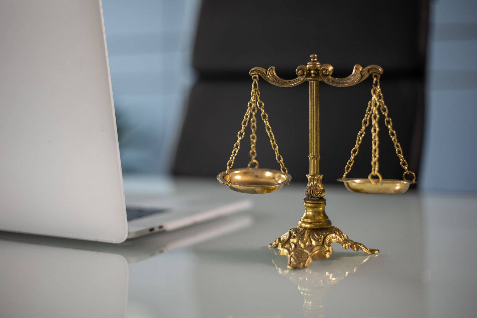 Brass scales of justice on a legal office desk